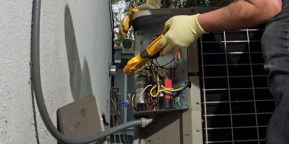 Image Of Employee Doing HVAC Maintenance